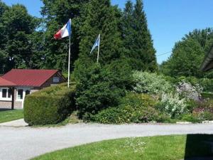 two flags flying in a yard next to a house at Les Insolites du Brochet in Péronne +7 photos