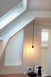 una luz colgando del techo de una habitación en Hotel Restaurant La Musardiere, en Giverny