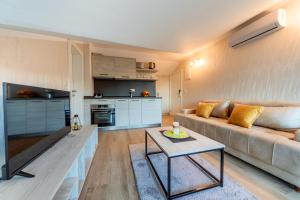 a living room with a couch and a table at Luxury Apartments Queen in Petrovac na Moru