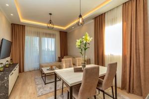 a living room with a table and a couch at Luxury Apartments Queen in Petrovac na Moru