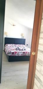Кровать или кровати в номере Appartamento Alissya