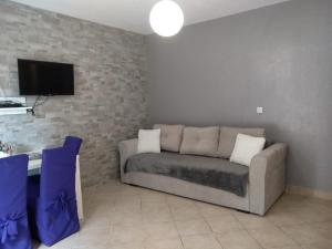 a living room with a couch and a tv at Apartments Laus in Zavalatica