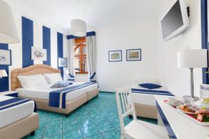 Ένα ή περισσότερα κρεβάτια σε δωμάτιο στο Hotel Herculaneum