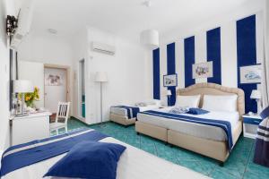 Ένα ή περισσότερα κρεβάτια σε δωμάτιο στο Hotel Herculaneum