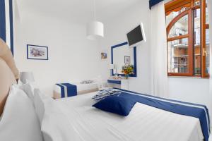 Ένα ή περισσότερα κρεβάτια σε δωμάτιο στο Hotel Herculaneum