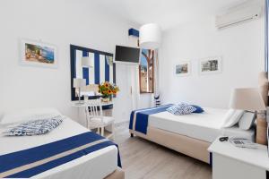 Ένα ή περισσότερα κρεβάτια σε δωμάτιο στο Hotel Herculaneum