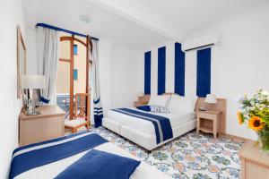 Ένα ή περισσότερα κρεβάτια σε δωμάτιο στο Hotel Herculaneum