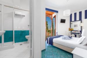 Ένα ή περισσότερα κρεβάτια σε δωμάτιο στο Hotel Herculaneum