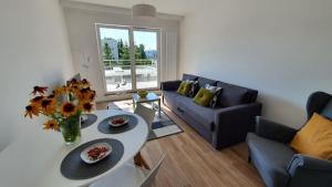a living room with a table and a couch at APARTAMENT WILKASY II (k. Giżycka ) in Wilkasy +32 photos
