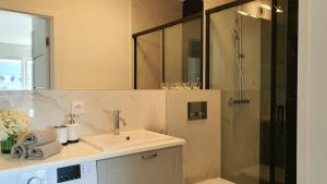 a bathroom with a sink and a shower at APARTAMENT WILKASY II (k. Giżycka ) in Wilkasy