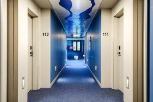 a hallway with blue walls and a blue ceiling at Hotel Spa Aguas de los Mallos in Murillo de Gállego
