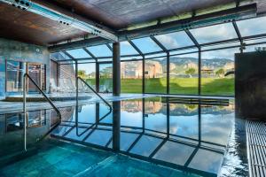 an indoor pool with a view of the mountains at Hotel Spa Aguas de los Mallos in Murillo de Gállego