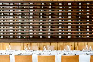 a dining room with a wine cellar at Hotel Spa Aguas de los Mallos in Murillo de Gállego