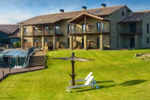 a large house with a large yard with a large building at Hotel Spa Aguas de los Mallos in Murillo de Gállego