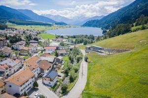 an aerial view of a small town with a train in the mountains at Chalet Ortles Apt ll in San Valentino alla Muta