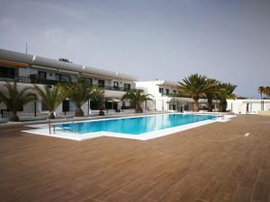 a large swimming pool in front of a building at Sand Dunes & Sun - Dunasol in Corralejo