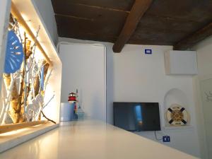 a living room with a tv on a wall at La casa nella Torretta in Formia