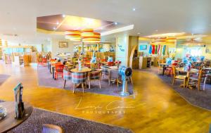 a restaurant with tables and chairs in a room at Sea 'n' Stars Platinum Plus Holiday home with Views, Free Wifi and Netflix in Camber