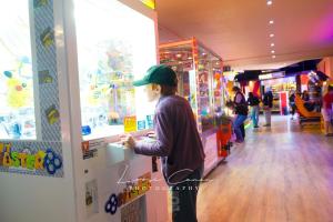 a young boy is looking at a game in a store at Sea 'n' Stars Platinum Plus Holiday home with Views, Free Wifi and Netflix in Camber