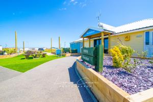 a building with a picnic table in a park at Sea 'n' Stars Platinum Plus Holiday home with Views, Free Wifi and Netflix in Camber