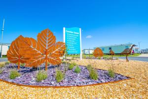 a display of plants in a park with a bench at Sea 'n' Stars Platinum Plus Holiday home with Views, Free Wifi and Netflix in Camber