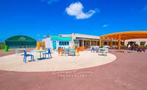 a group of chairs and tables in a patio at Sea 'n' Stars Platinum Plus Holiday home with Views, Free Wifi and Netflix in Camber
