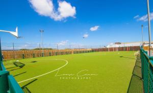 a green soccer field with a goal on it at Sea 'n' Stars Platinum Plus Holiday home with Views, Free Wifi and Netflix in Camber