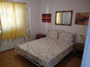 a bedroom with a bed and a mirror at Apartments & Rooms Abba in Dubrovnik