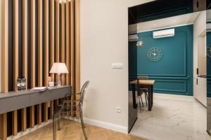 a room with a desk and a table with a chair at Luxury Number 1 Apartments in Rijeka