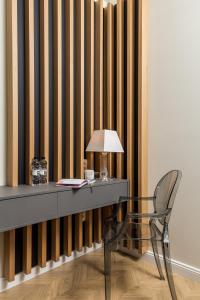 a desk with a lamp and a chair in a room at Luxury Number 1 Apartments in Rijeka