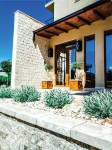 a house with a stone path leading to the front door at LaCasa Apartments Ulcinj in Ulcinj