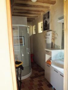 a bathroom with a glass shower and a sink at Gîte de charme Floréales Les Iris in Asnelles