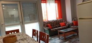 a living room with a couch and a table at Apartamento Mar deluxe Suances in Suances +6 photos