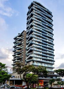 a tall building with cars parked in front of it at FR Hotel in Ibagué