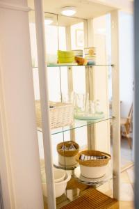 a glass shelf with bowls and baskets on it at Pod Aniołem in Mielno +157 photos