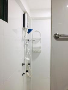 a shower in a bathroom with a glass door at Senthil Complex in Jaffna