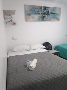 Łóżko lub łóżka w pokoju w obiekcie Suite Trujillo
