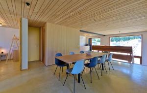 a dining room with a wooden table and chairs at Duinvis 15 in Oostduinkerke