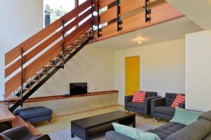 a living room with a couch and a staircase at Duinvis 15 in Oostduinkerke