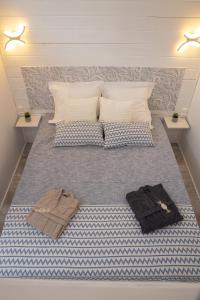 a bedroom with a bed with two towels on it at Le chalet aux Etoiles Spa & Sauna in Pézenas +21 photos