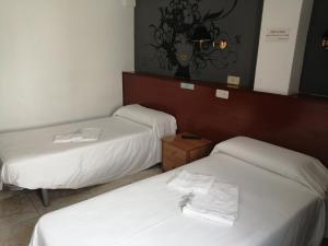 Rúm í herbergi á Hostal Jaime I