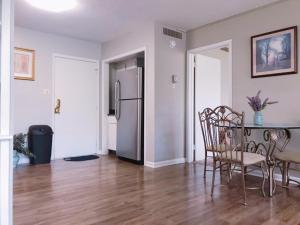 a kitchen with a table and chairs and a refrigerator at Downtown Apartment convenient to all city venues 105 in Greensboro