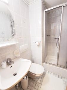 a bathroom with a sink and a toilet and a shower at Haus Marienheim in Heiligenblut