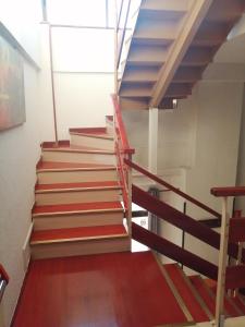 a staircase in an office building with red and blue stairs at Hostal Jaime I in Huesca
