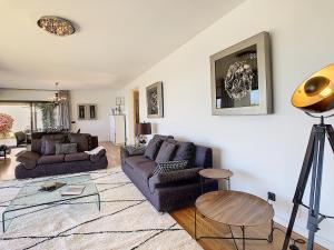 a living room with two couches and a table at Villa Vitoria - by LovelyStay in Funchal