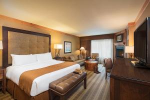 a hotel room with a large bed and a living room at Wyoming Inn of Jackson Hole in Jackson
