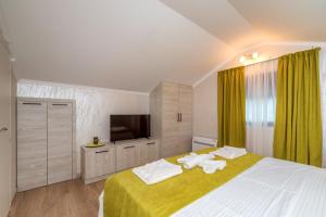 a bedroom with a large bed with towels on it at Luxury Apartments Queen in Petrovac na Moru