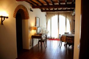 a living room with a table and a window at Villa Santa Maddalena in Cetona