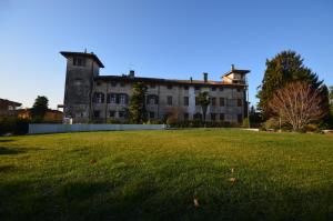 ein großes Gebäude mit einem Grasfeld davor in der Unterkunft Al Castello di Aiello in Aiello del Friuli