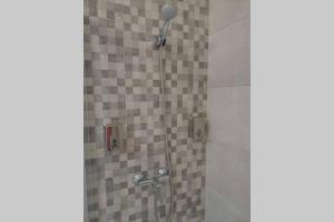 a shower with a glass door with a shower head at Apartamento Lalín Centro ll in Lalín +20 photos